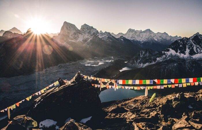 Panoramic view of Gangtok city nestled in the Himalayas with prayer flags, monasteries, and scenic mountain backdrop