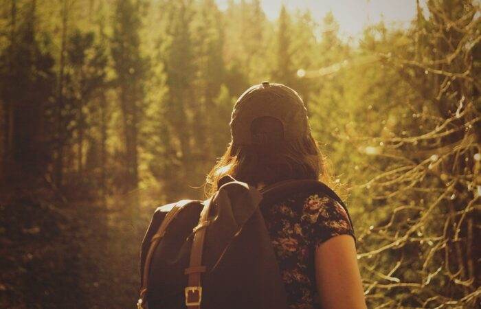 Hiker trekking through a rugged mountain trail, symbolizing adventure travel and nature exploration featured in blog posts